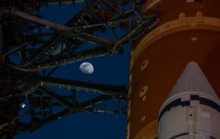 Moon Seen Shining on Full Artemis II Stack at Launch Pad 39B