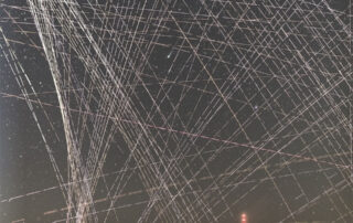 Comet R3 PanSTARRS Behind Satellite Trails