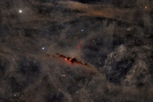 The Red Glow of the Cosmic Bat Nebula