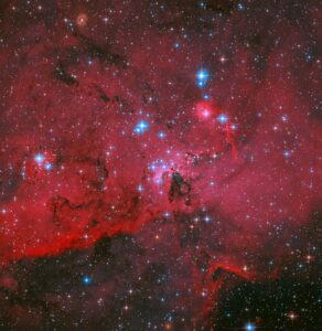 hubble-sees-crimson-cloud-and-stars