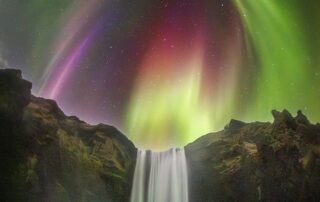 Colorful Aurora over Icelandic Waterfall